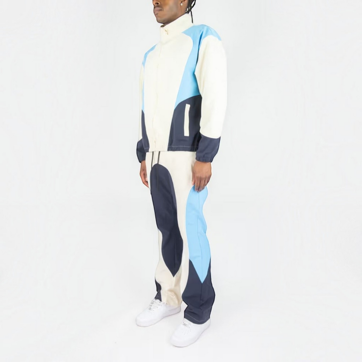 Rebel Minds cream, blue, and navy ripstop windbreaker jacket and flare-fit pants set worn by a model