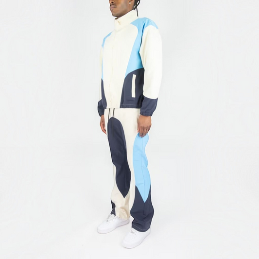 Rebel Minds cream, blue, and navy ripstop windbreaker jacket and flare-fit pants set worn by a model