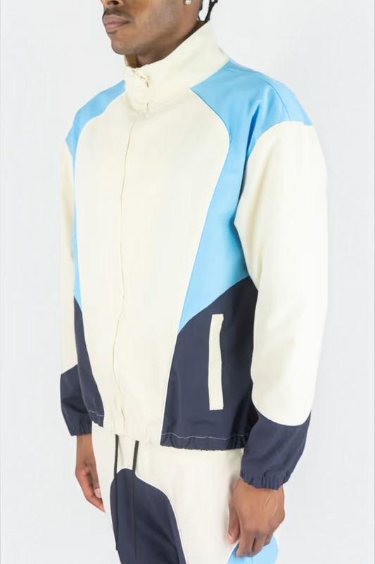 Rebel Minds cream, light blue, and navy ripstop windbreaker jacket with a high collar and matching flare-fit pants.
