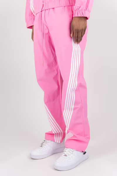 Rebel Minds pink crinkled nylon pants featuring white bent contrast stripes and an adjustable drawstring waist